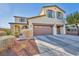 Two-story house with a two-car garage and nicely landscaped front yard at 10611 Auburn Springs Ave, Las Vegas, NV 89166