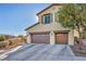 Two-story house with a two-car garage and desert landscaping at 10611 Auburn Springs Ave, Las Vegas, NV 89166