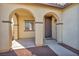 Home exterior featuring a welcoming front porch with arched entryway at 10611 Auburn Springs Ave, Las Vegas, NV 89166