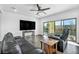 Bright living room with dark hardwood floors,sliding glass doors, and a ceiling fan at 10611 Auburn Springs Ave, Las Vegas, NV 89166