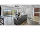 Bright living room with dark hardwood floors,sliding glass doors, and a ceiling fan at 10611 Auburn Springs Ave, Las Vegas, NV 89166