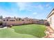 Landscaped backyard with putting green and patio at 1064 Wide Brim Ct, Henderson, NV 89011