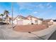 Single-story house with pink garage door, solar panels, and desert landscaping at 1064 Wide Brim Ct, Henderson, NV 89011