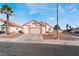 Single-story house with pink garage door and desert landscaping at 1064 Wide Brim Ct, Henderson, NV 89011