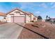 Single-story house with pink garage door and landscaped yard at 1064 Wide Brim Ct, Henderson, NV 89011