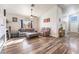 Living room with fireplace, wood floors, and comfy seating at 1064 Wide Brim Ct, Henderson, NV 89011