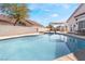 Relaxing pool and patio area with a pergola and lush landscaping at 1064 Wide Brim Ct, Henderson, NV 89011