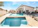 Resort-style backyard pool and spa with patio furniture at 1064 Wide Brim Ct, Henderson, NV 89011