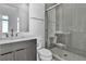 Contemporary bathroom featuring a gray vanity with a marble countertop and a glass-enclosed shower at 10739 Agate Cliffs Ave, Las Vegas, NV 89135