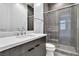 Modern bathroom with gray tile shower and marble vanity at 10739 Agate Cliffs Ave, Las Vegas, NV 89135