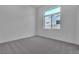 Spacious bedroom with gray carpet and large window at 10739 Agate Cliffs Ave, Las Vegas, NV 89135