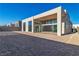 Modern home exterior with clean lines and large windows, showcasing a backyard patio at 10739 Agate Cliffs Ave, Las Vegas, NV 89135