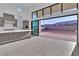 Modern kitchen with gray cabinets, a large sliding glass door, and expansive views of the outside at 10739 Agate Cliffs Ave, Las Vegas, NV 89135