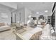 This virtually staged living room features a kitchen and a large open space for living and dining at 10739 Agate Cliffs Ave, Las Vegas, NV 89135