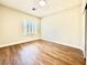 Well-lit bedroom featuring wood-look floors and window shutters at 109 Lakewood Garden Dr, Las Vegas, NV 89148