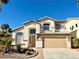 Beautiful two-story home with a beige exterior and a two-car garage at 109 Lakewood Garden Dr, Las Vegas, NV 89148