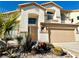 Stunning two-story house featuring a light beige exterior and landscaping at 109 Lakewood Garden Dr, Las Vegas, NV 89148