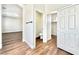 Hallway with wood-look floors, toilet and walk-in closet at 109 Lakewood Garden Dr, Las Vegas, NV 89148