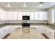 Modern kitchen featuring white cabinets and granite countertops at 109 Lakewood Garden Dr, Las Vegas, NV 89148