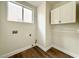 Laundry room with overhead cabinets and a rod for hanging clothes at 109 Lakewood Garden Dr, Las Vegas, NV 89148