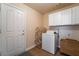 Laundry room with washer, dryer, and built-in cabinets at 1105 Thornfield Ln, Las Vegas, NV 89123