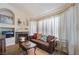 Cozy living room with fireplace and large windows at 1105 Thornfield Ln, Las Vegas, NV 89123