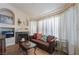 Cozy living room with fireplace and large windows at 1105 Thornfield Ln, Las Vegas, NV 89123