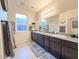 Double vanity bathroom with granite countertop and walk-in shower at 1297 Paseo Del Oso Ln, Henderson, NV 89002