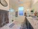 Bathroom with shower/tub combo, vanity, and window at 1297 Paseo Del Oso Ln, Henderson, NV 89002