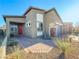 Single-story house with red door and a stone accent wall near the garage at 1297 Paseo Del Oso Ln, Henderson, NV 89002