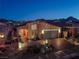 Night view of a single-story home with landscaping and a paved driveway at 1297 Paseo Del Oso Ln, Henderson, NV 89002