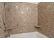 Bathroom with a bathtub and beige marble-style shower surround at 150 Las Vegas Blvd # 1903, Las Vegas, NV 89101