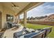 Relaxing covered patio with seating area, overlooking a grassy backyard at 1738 Sonoran Bluff Ave, Henderson, NV 89014