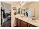 Bathroom with a double sink vanity, a large mirror, and access to a well-lit bedroom at 1738 Sonoran Bluff Ave, Henderson, NV 89014