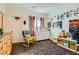 Well-lit bedroom with a window, dresser, comfortable chair, and toys, perfect for relaxation and play at 1738 Sonoran Bluff Ave, Henderson, NV 89014