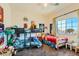 Spacious bedroom featuring a bunk bed, a twin bed, and a large window with natural light at 1738 Sonoran Bluff Ave, Henderson, NV 89014