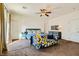 Carpeted bedroom with bright accent pillows and ceiling fan at 1738 Sonoran Bluff Ave, Henderson, NV 89014