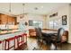 Spacious dining area with booth seating, wood floors, and kitchen island view at 1738 Sonoran Bluff Ave, Henderson, NV 89014