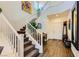 Bright entryway with staircase, wood flooring, and large sunflower art at 1738 Sonoran Bluff Ave, Henderson, NV 89014