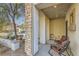 Cozy front porch with comfortable seating, stone pillars, and a decorative birdhouse, perfect for relaxation at 1738 Sonoran Bluff Ave, Henderson, NV 89014