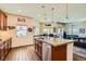 Bright kitchen featuring granite island, stainless appliances and a view to living room at 1738 Sonoran Bluff Ave, Henderson, NV 89014