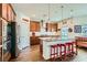 Kitchen with stainless steel appliances, granite countertops, island, and red accents at 1738 Sonoran Bluff Ave, Henderson, NV 89014