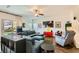 Bright living room with a comfortable sectional sofa, a ceiling fan, and sliding glass doors leading to the outside at 1738 Sonoran Bluff Ave, Henderson, NV 89014