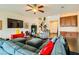 Comfortable living room featuring a spacious sectional sofa, a ceiling fan, and seamless access to the staircase at 1738 Sonoran Bluff Ave, Henderson, NV 89014