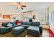 Spacious living room with a comfortable sectional sofa, a ceiling fan, and an open layout connecting to the kitchen area at 1738 Sonoran Bluff Ave, Henderson, NV 89014