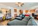 Open-concept living room with a cozy sectional sofa, and a view of the kitchen and staircase, creating a seamless flow at 1738 Sonoran Bluff Ave, Henderson, NV 89014