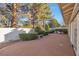 Spacious backyard with a concrete patio, manicured hedges, and a stone bench at 1901 Calle De Espana, Las Vegas, NV 89102