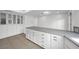 White kitchen with gray countertops and glass-front cabinets at 1901 Calle De Espana, Las Vegas, NV 89102