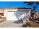 Single car garage with white door and driveway at 2204 Kendall Hill Ave, Las Vegas, NV 89106