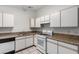 White kitchen features granite countertops and ample cabinet space at 2204 Kendall Hill Ave, Las Vegas, NV 89106